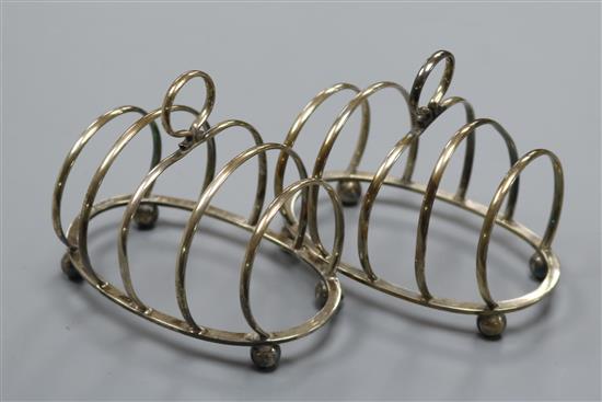 A pair of 1930s Asprey & Co silver five bar toast racks, Birmingham, 1937, 4 oz.